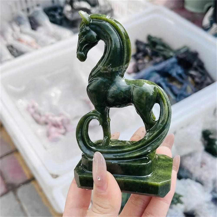 Hand-carved green serpentinite horse figurine with deep forest tones and dark veining for heart chakra grounding.