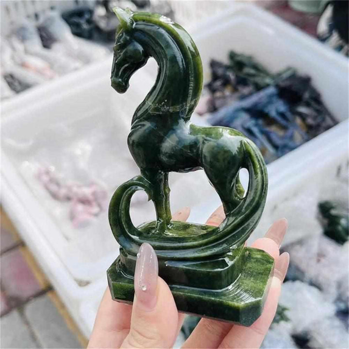 Hand-carved green serpentinite horse figurine featuring deep forest tones and grounding energy for the Heart chakra.