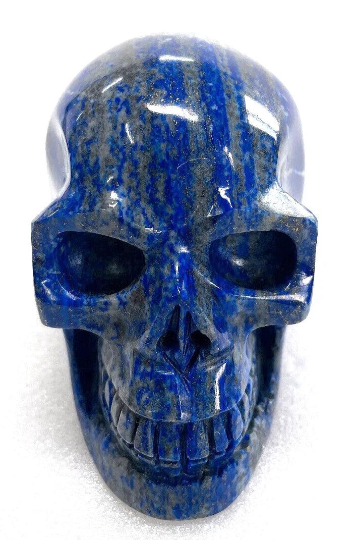 Polished natural Lapis Lazuli crystal skull with deep blue hues and gold flecks for powerful healing and home decor.