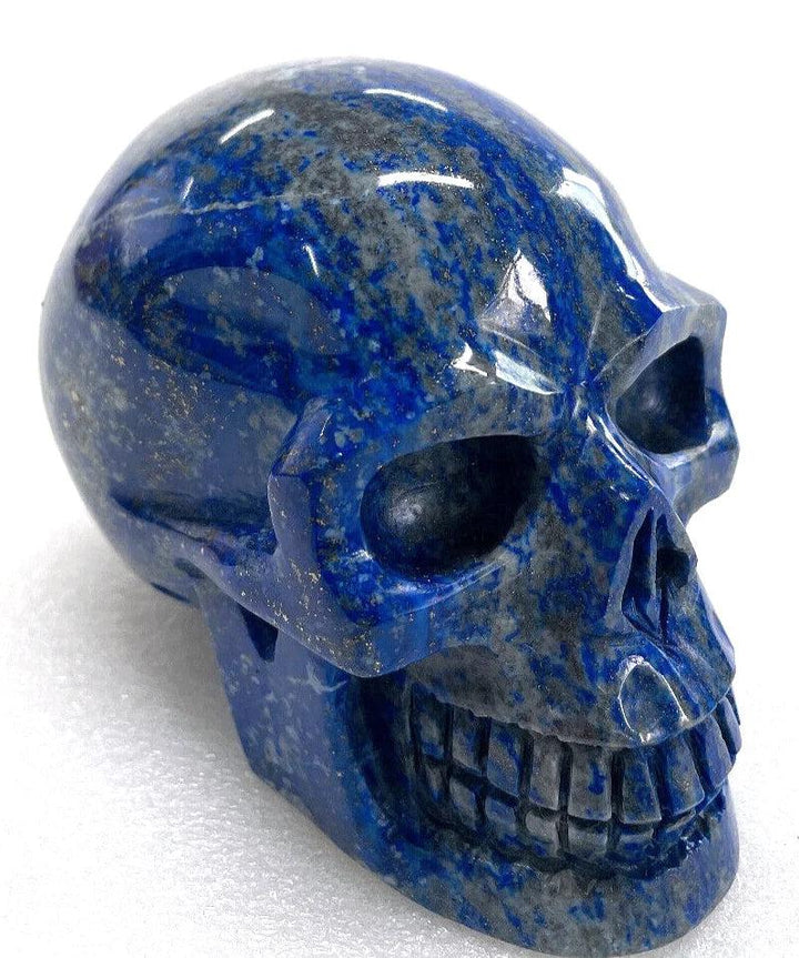 Polished natural Lapis Lazuli crystal skull with deep blue hues for healing, spiritual energy, and unique home decor.