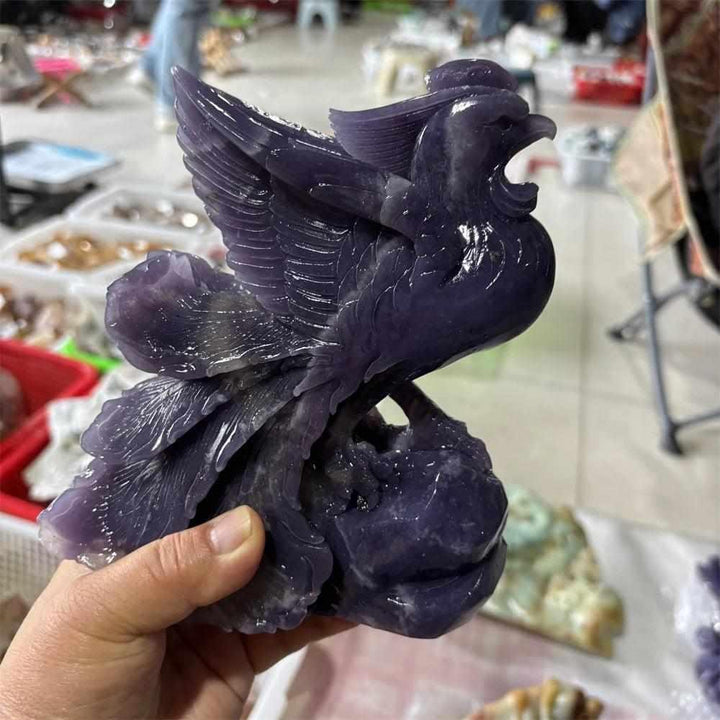 Hand-carved natural lepidolite phoenix figurine with a violet, shimmering finish for crown chakra spiritual connection.