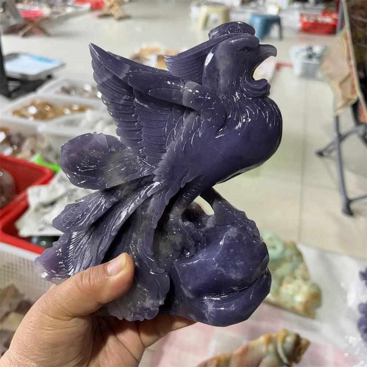 Hand-carved violet Lepidolite phoenix figurine with shimmering layered detail for Crown and Third Eye chakra healing.