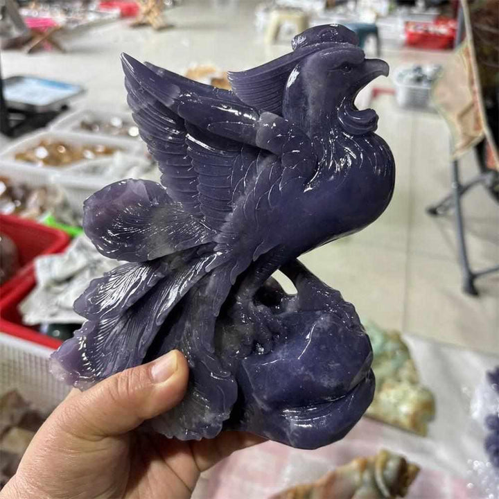 Hand-carved violet Lepidolite phoenix figurine with shimmering layered detail for Crown and Third Eye chakra healing.