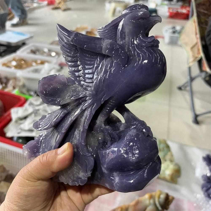 Hand-carved violet lepidolite phoenix figurine with shimmering layered detail for Crown and Third Eye chakra healing.
