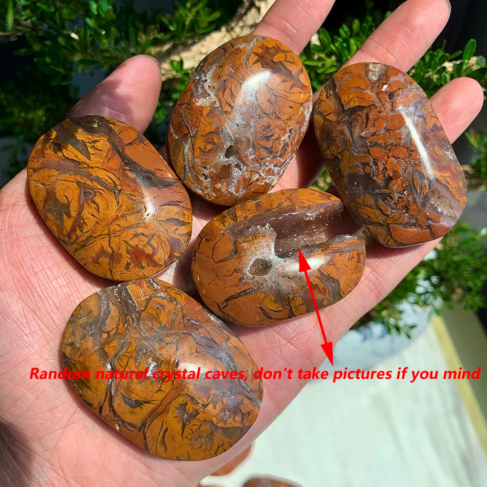 Polished Maligano Jasper palm stones featuring swirling cream, rust, and brown patterns with unique natural crystal caves.