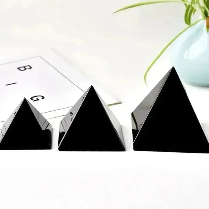 Three polished, jet-black Natural Obsidian Pyramids from Crystal Destiny, varying in size, for grounding energy.