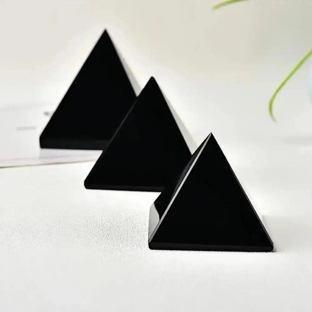 Three polished, jet-black Natural Obsidian Pyramids from Crystal Destiny, ideal for grounding and protection.