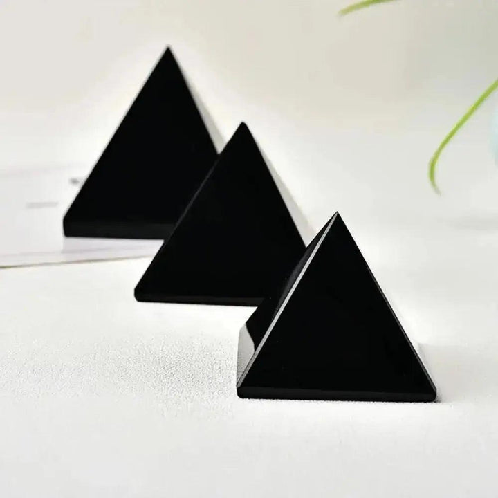 Three polished, jet-black Natural Obsidian Pyramids from Crystal Destiny, ideal for grounding and protection.