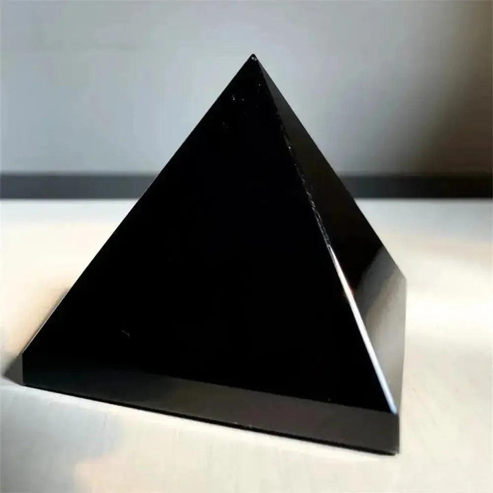 Smooth, jet-black Natural Obsidian Pyramid from Crystal Destiny, ideal for grounding and protection.