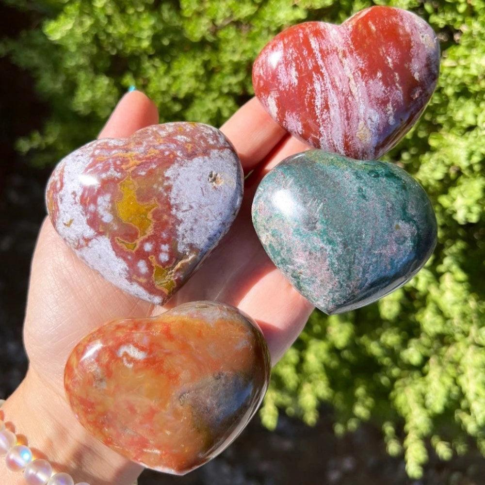Polished Ocean Jasper heart crystals in vibrant green, red, and tan orb patterns, perfect for heart chakra healing.