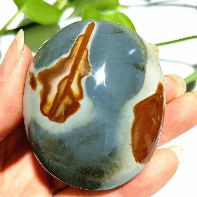 Polished Polychrome Jasper palm stone with rust and sage bands, perfect for grounding meditation and stress relief.