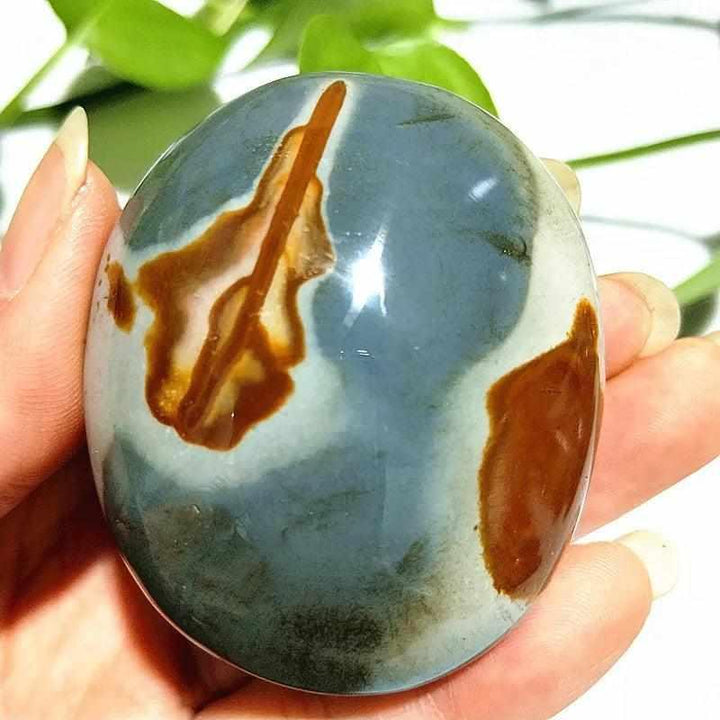 Polished Polychrome Jasper palm stone with rust and sage bands, perfect for grounding meditation and stress relief.