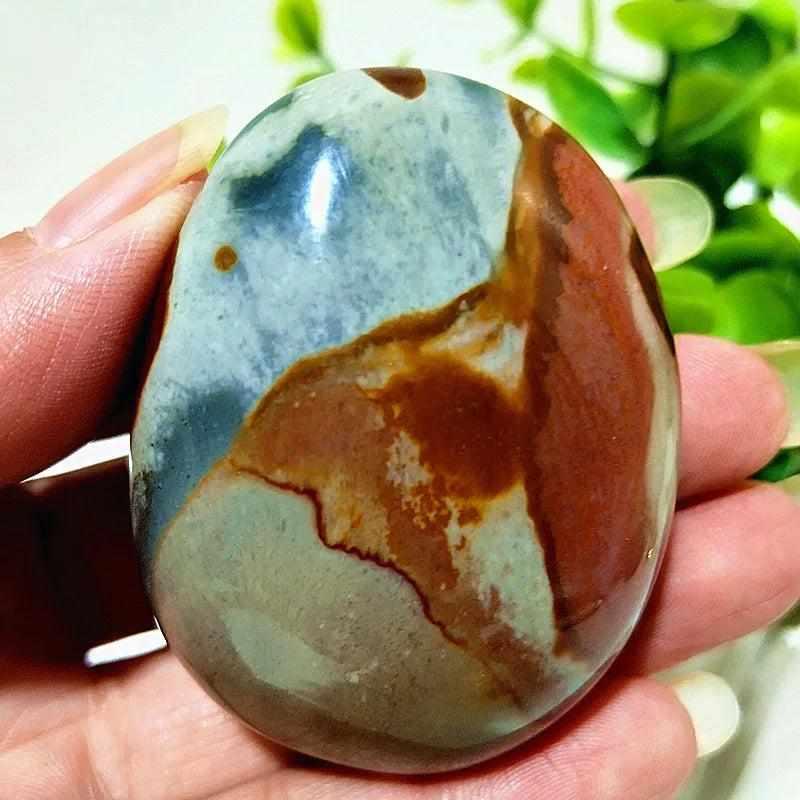 Polished Polychrome Jasper palm stone with earthy rust, cream, and sage bands for grounding meditation and stress relief.