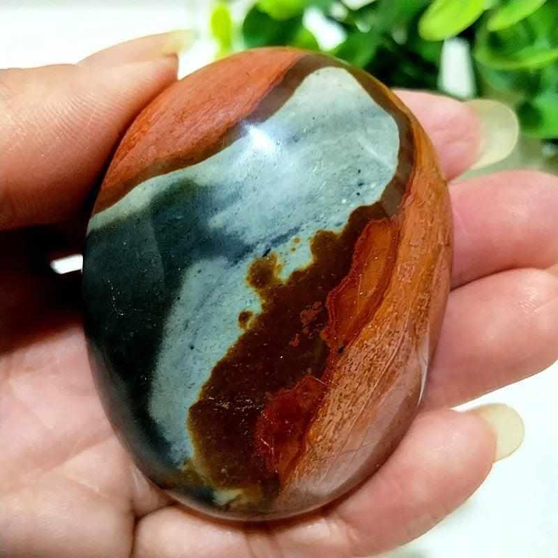 Polished Polychrome Jasper palm stone with earthy rust, cream, and sage bands for grounding and meditation.