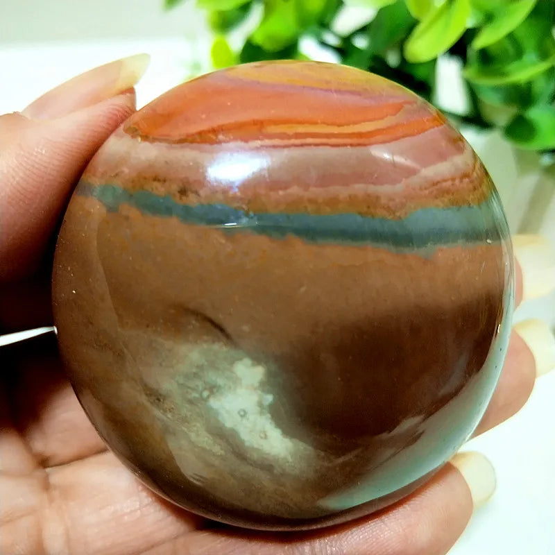 Polished Polychrome Jasper palm stone with earthy rust, cream, and sage bands for grounding meditation and stress relief.