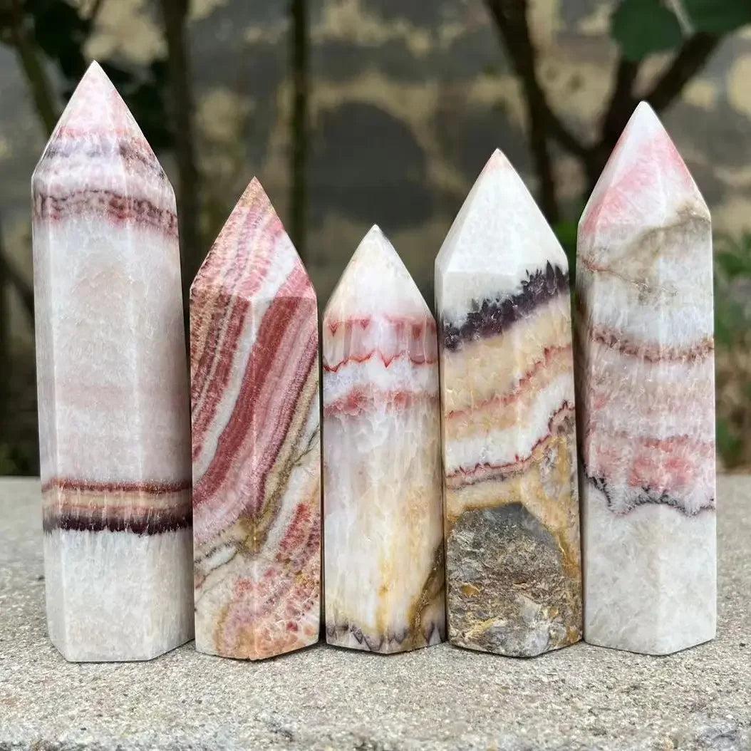 Polished Natural Pork Stone Calcite hexagonal towers with cream, rust, and brown marbling for Root Chakra grounding.