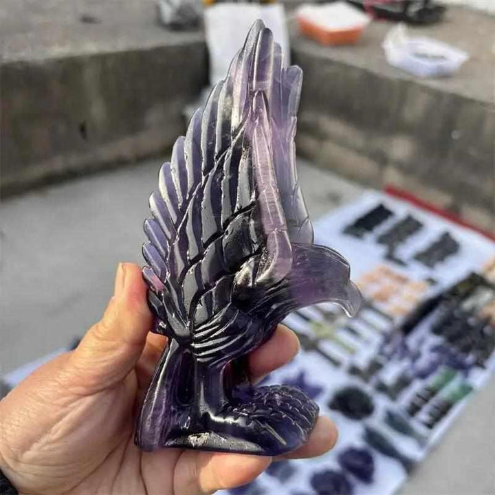 Hand-carved purple fluorite eagle figurine featuring deep violet banding for Third Eye chakra clarity and intuition.