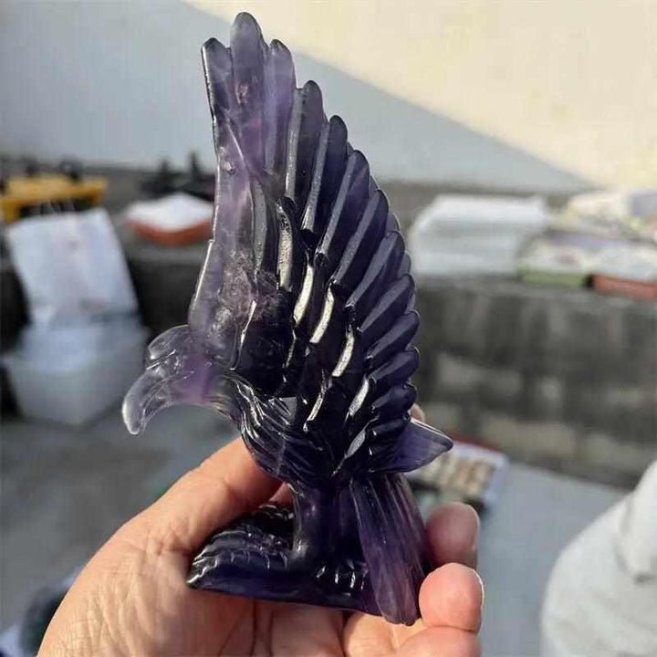 Natural purple fluorite eagle figurine with deep violet banding, carved for Third Eye chakra clarity and intuition.