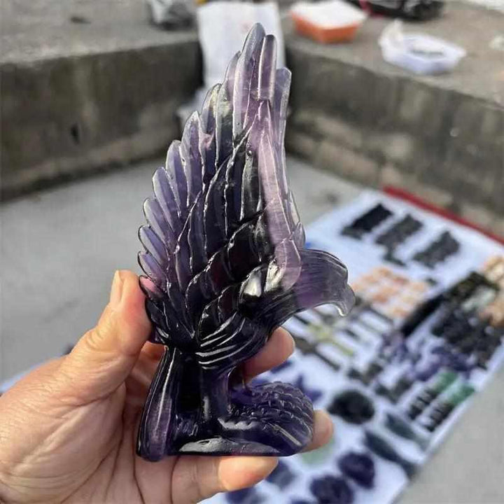 Hand-carved natural purple fluorite eagle figurine featuring deep violet and lavender banding for Third Eye chakra focus.
