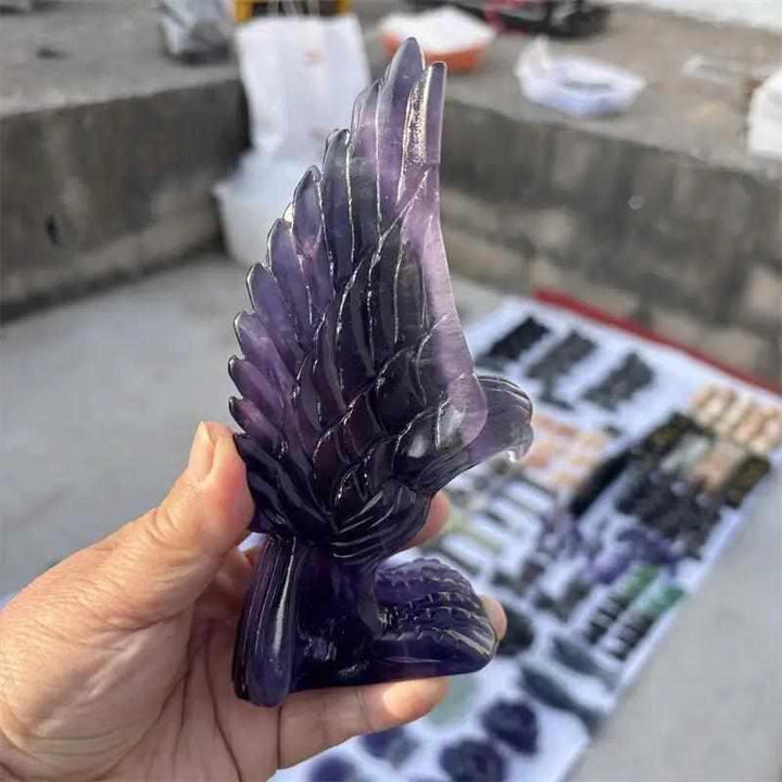 Hand-carved purple fluorite eagle figurine featuring deep violet banding for Third Eye chakra clarity and intuition.