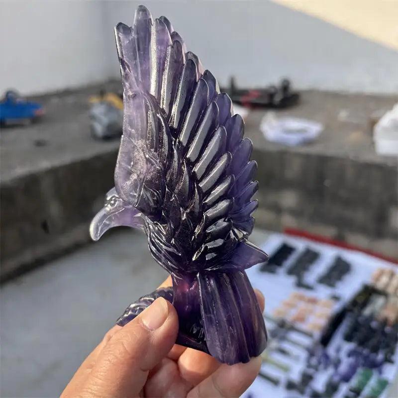 Natural purple fluorite eagle figurine with deep violet banding, carved for Third Eye chakra clarity and spiritual vision.