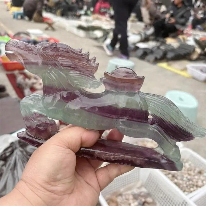 Hand-carved rainbow fluorite horse figurine featuring vibrant purple and green banding for Third Eye chakra clarity.