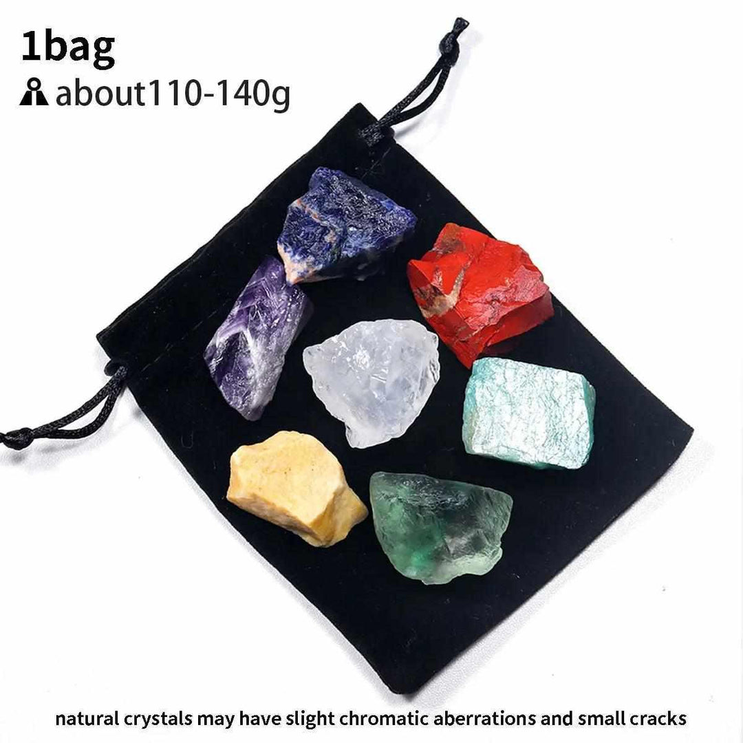 Natural raw 7 chakra crystal healing kit featuring seven colorful, textured stones in a black velvet drawstring pouch.