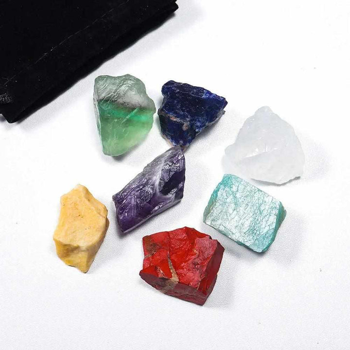 Natural raw 7 chakra crystal healing kit with vibrant, textured stones for grounding, energy balancing, and meditation.