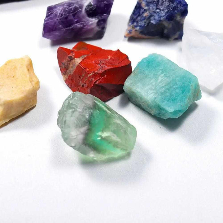 7 Chakra Healing Kit featuring raw, natural stones in vibrant colors for grounding, balance, and spiritual energy.