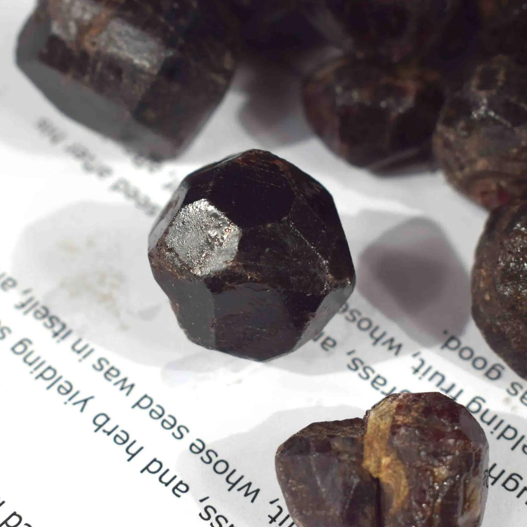 Rough, dark red natural Garnet crystal, a faceted raw gemstone mineral for healing and spiritual gifts.