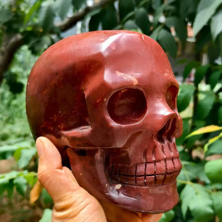 Hand-polished natural red jasper skull, a smooth healing crystal carving with deep crimson tones for Reiki and decor.