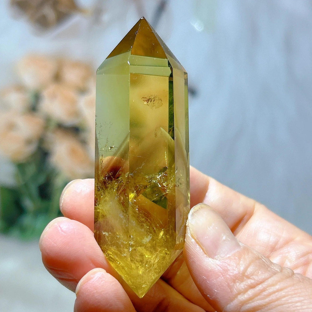 Natural yellow Citrine double tower crystal, held in hand, for energy healing and home decor.