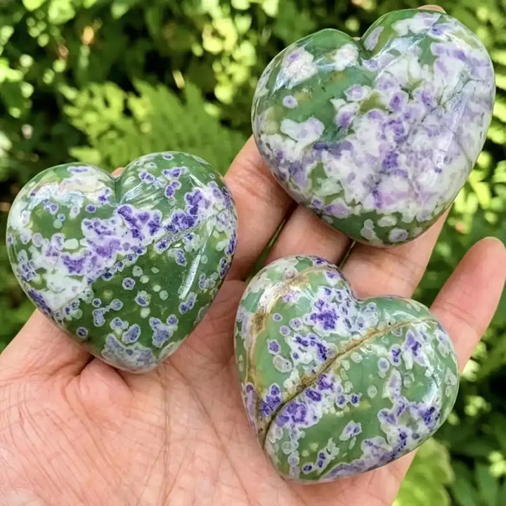 Polished natural snowflake jade heart carvings with green and purple patterns, perfect for healing and home decor.