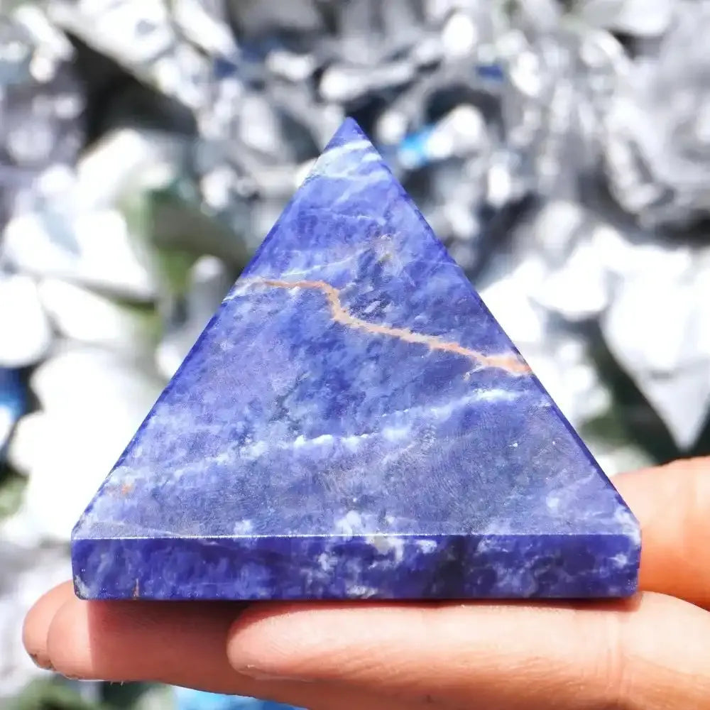 Handheld Natural Sodalite Crystal Pyramid with deep blue stone, elegant geometric design for home decor and healing.