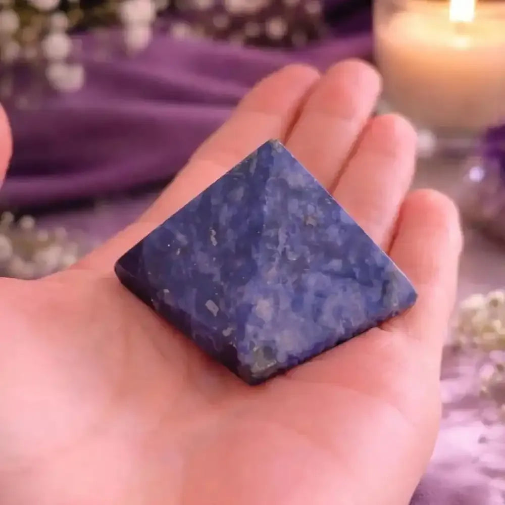 Handheld Natural Sodalite Crystal Pyramid featuring deep blue stone with unique patterns for elegant home decor and healing.