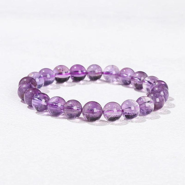 Smooth purple Amethyst beaded bracelet, a natural stone crystal design for healing and grounding on an elastic band.