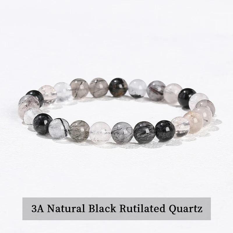 Natural Black Rutilated Quartz beaded bracelet, a grounding stretch crystal accessory with unique needle-like inclusions.