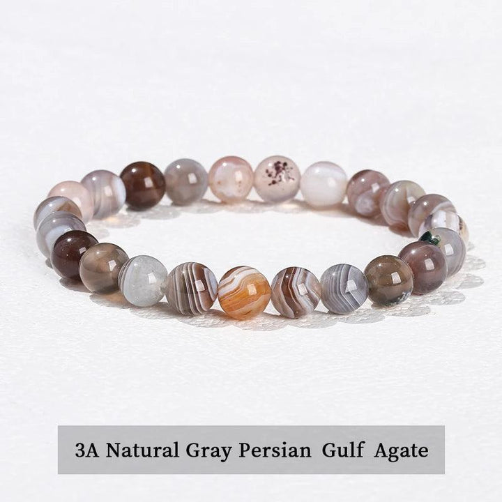 Natural stone beaded bracelet featuring smooth, banded gray Persian Gulf Agate beads on a comfortable elastic stretch band.