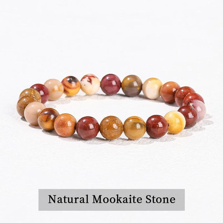 Natural Mookaite stone beaded bracelet featuring smooth, earthy red and yellow crystals on a comfortable stretch band.