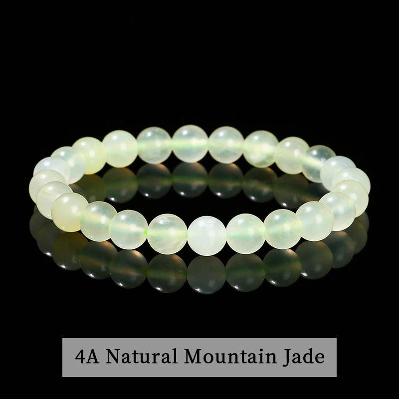 Stretchable Natural Mountain Jade beaded bracelet with smooth, pale green crystals for grounding and healing energy.