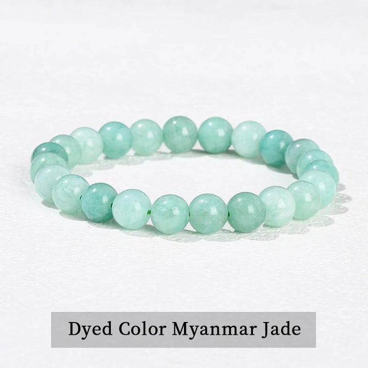 Natural stone beaded bracelet in dyed Myanmar jade, featuring smooth, light green elastic beads for healing energy.