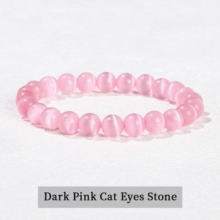Natural stone beaded bracelet in dark pink cat eye, a smooth elastic crystal design for heart chakra healing and energy.