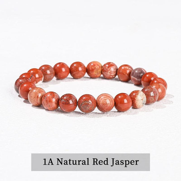 Grounding red jasper beaded bracelet, a natural stone stretch accessory for root chakra healing and daily wear.