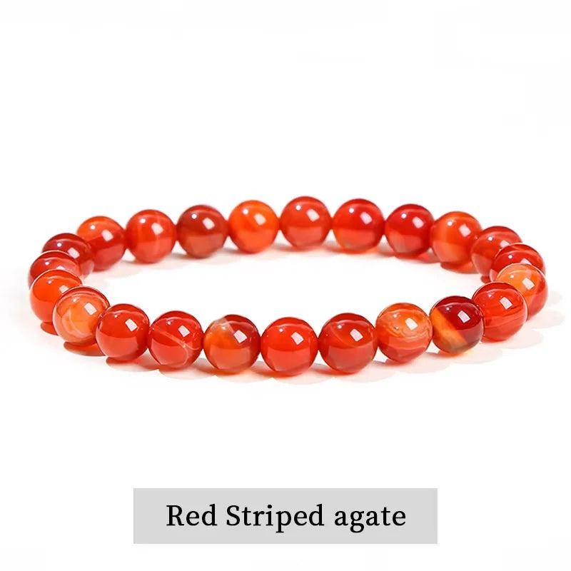 Red striped agate beaded bracelet, a grounding natural stone stretch accessory for balancing the root and sacral chakras.