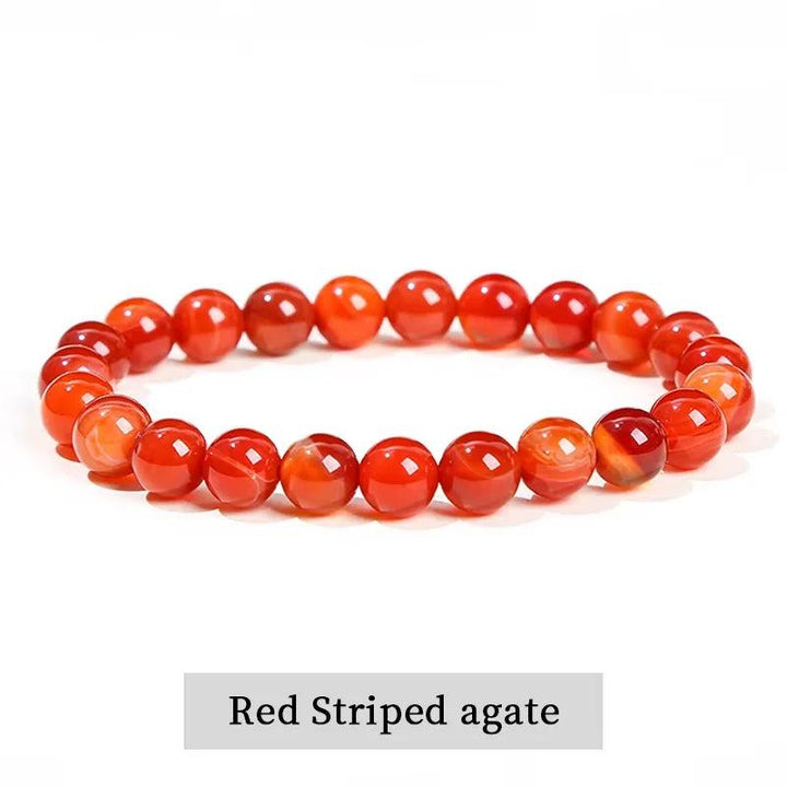 Red striped agate beaded bracelet, a grounding natural stone stretch accessory for balancing the root and sacral chakras.