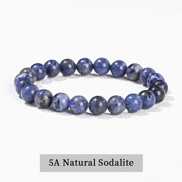 Natural Sodalite beaded bracelet, a grounding crystal stretch accessory featuring smooth, deep blue gemstone spheres.