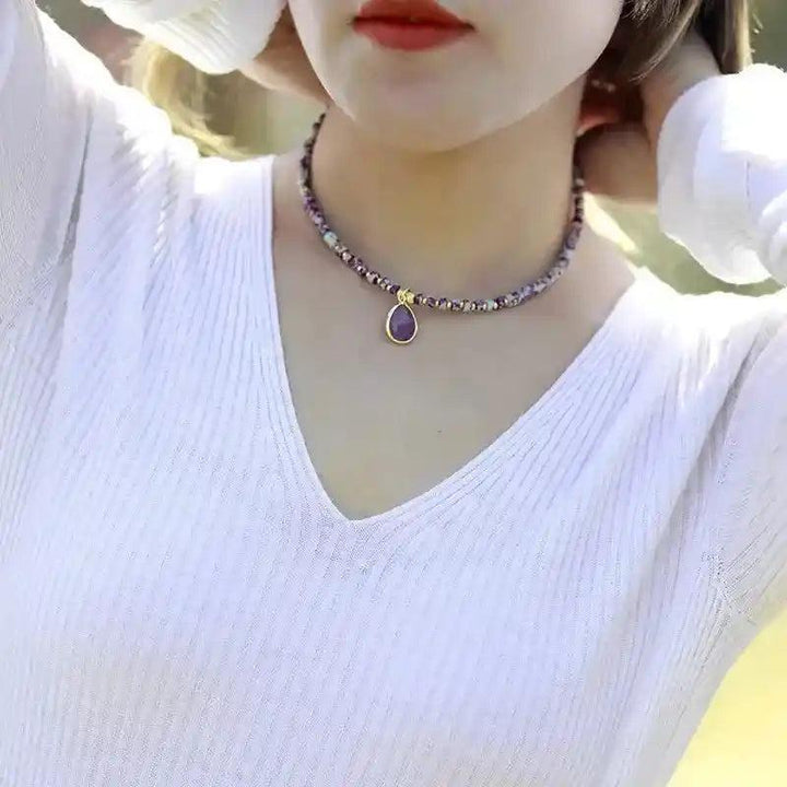 Natural Stone Teardrop Choker Necklace with purple gemstone beads and a gold teardrop pendant, exuding elegance.