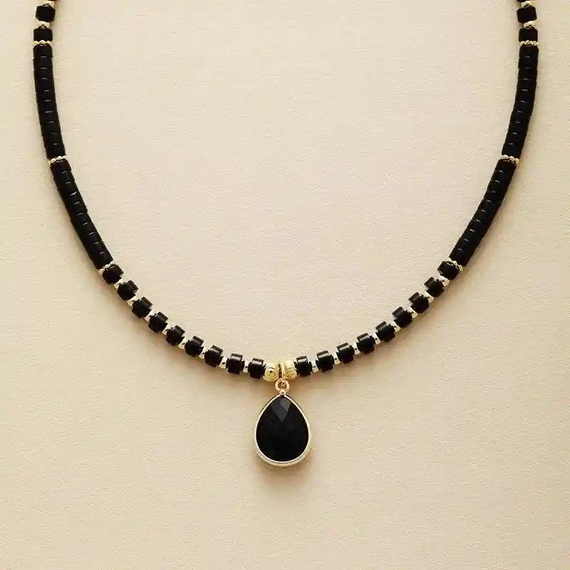Elegant Natural Stone Teardrop Choker Necklace with black onyx beads and a gold-framed teardrop pendant.