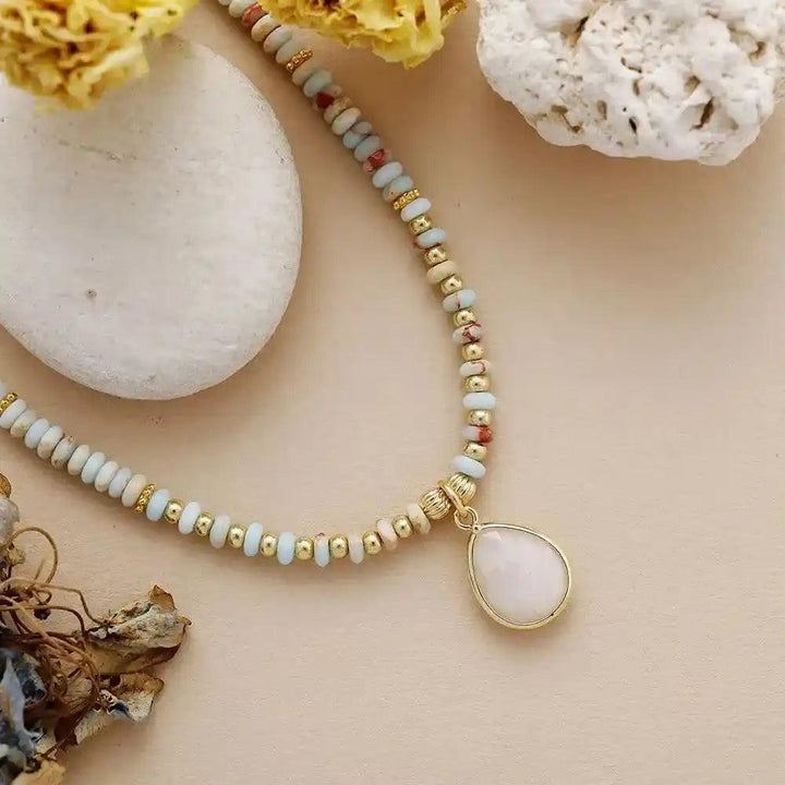 Natural Stone Teardrop Choker Necklace with light blue, pink, and gold beads, featuring a white teardrop pendant.