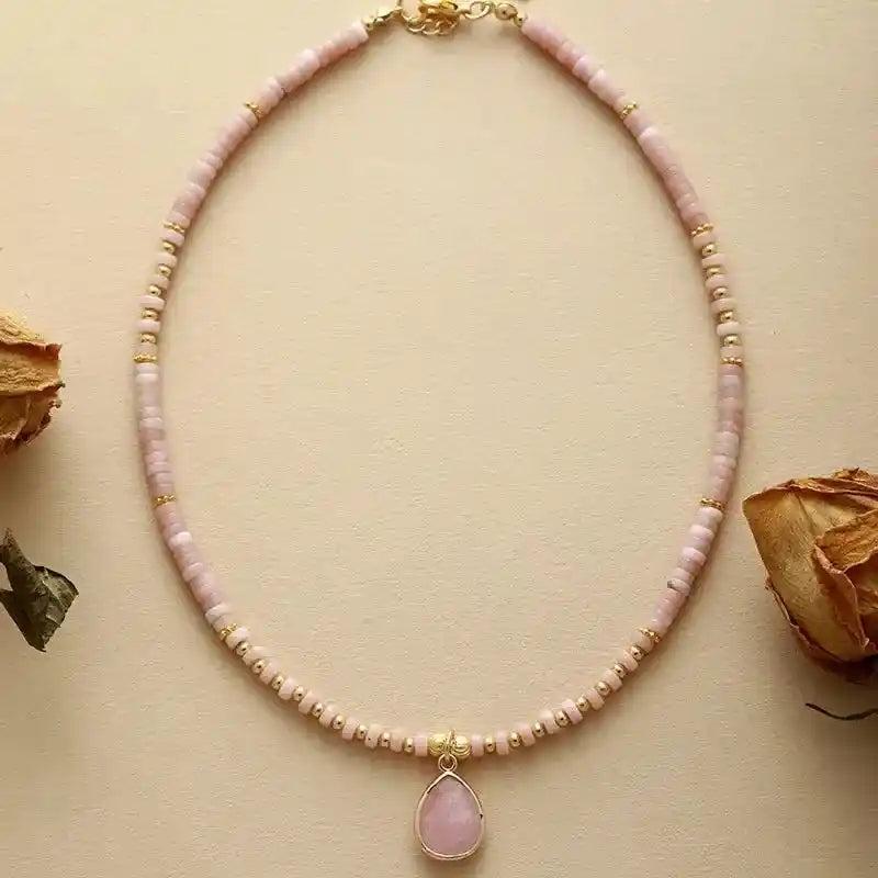 Natural Stone Teardrop Choker Necklace with pink gemstone beads and gold accents, radiating unique energy.